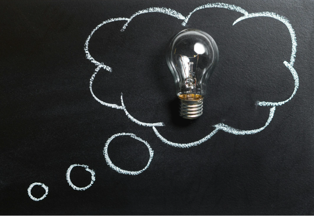 Clear light bulb placed on chalkboard clear-light-bulb-placed-on-chalkboard