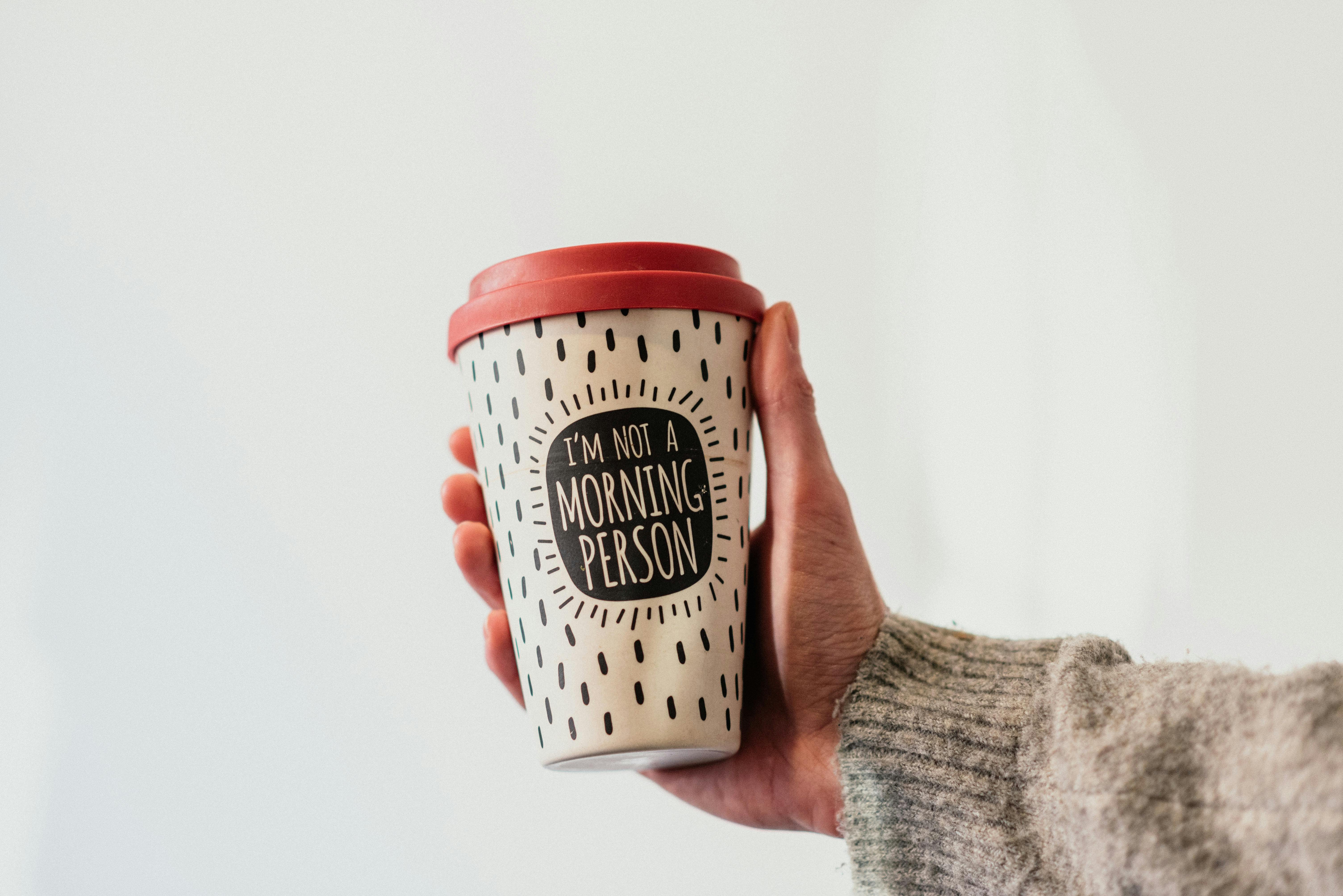 faceless-person-showing-inscription-on-coffee-to-go