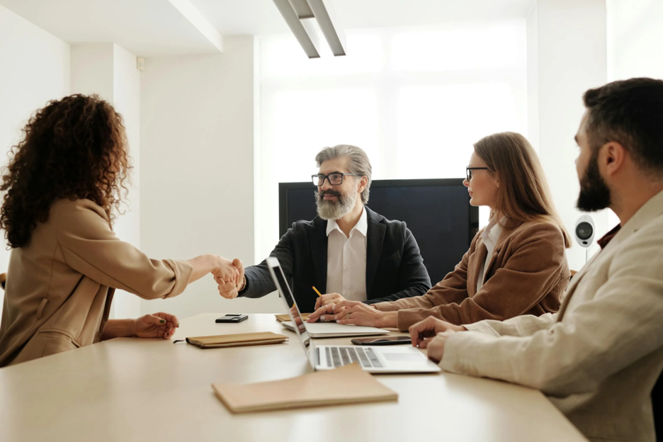 executives-gathered-around-a-conference-table-as-they-onboard-a-new-employee