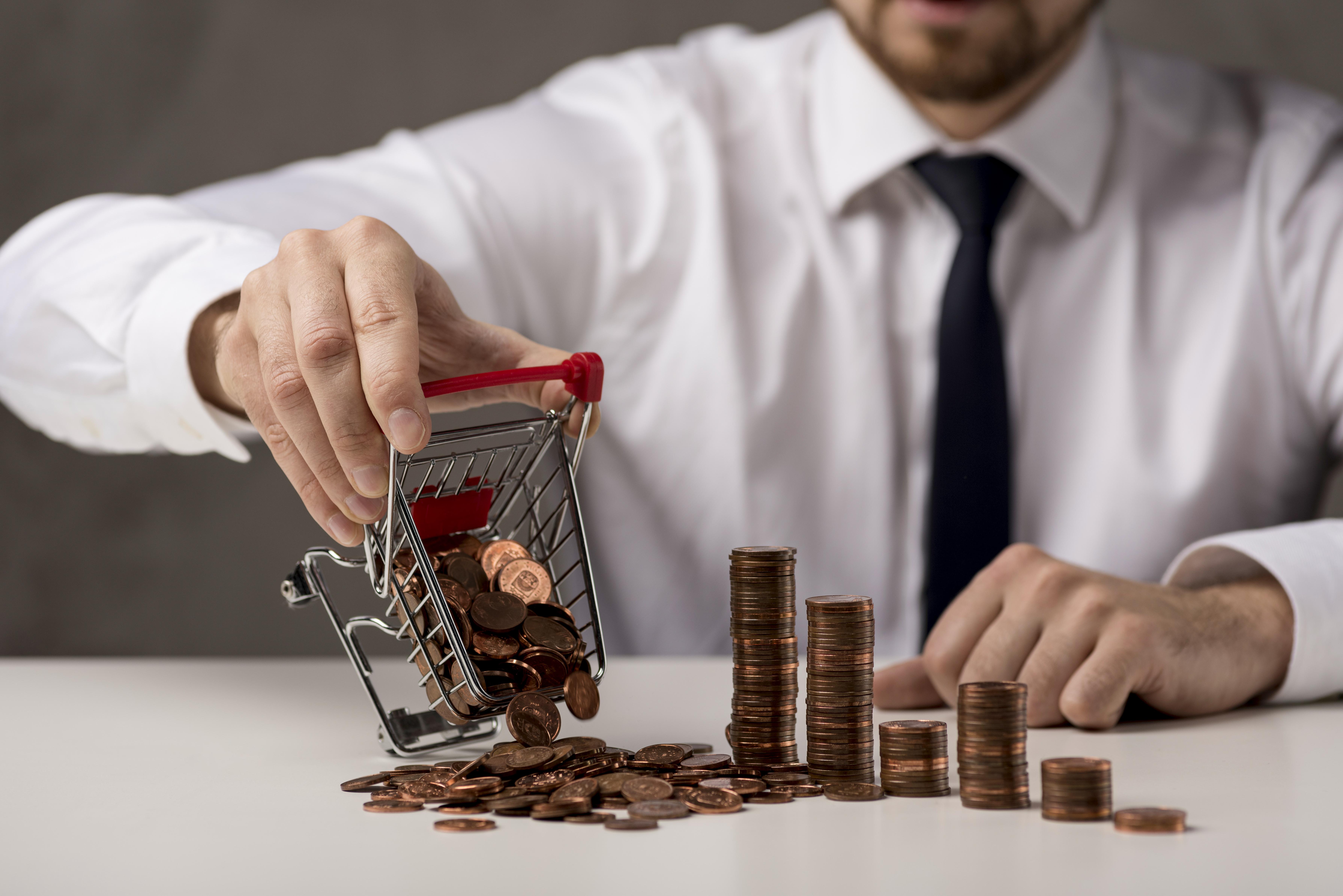 front-view-businessman-spilling-shopping-cart-coins