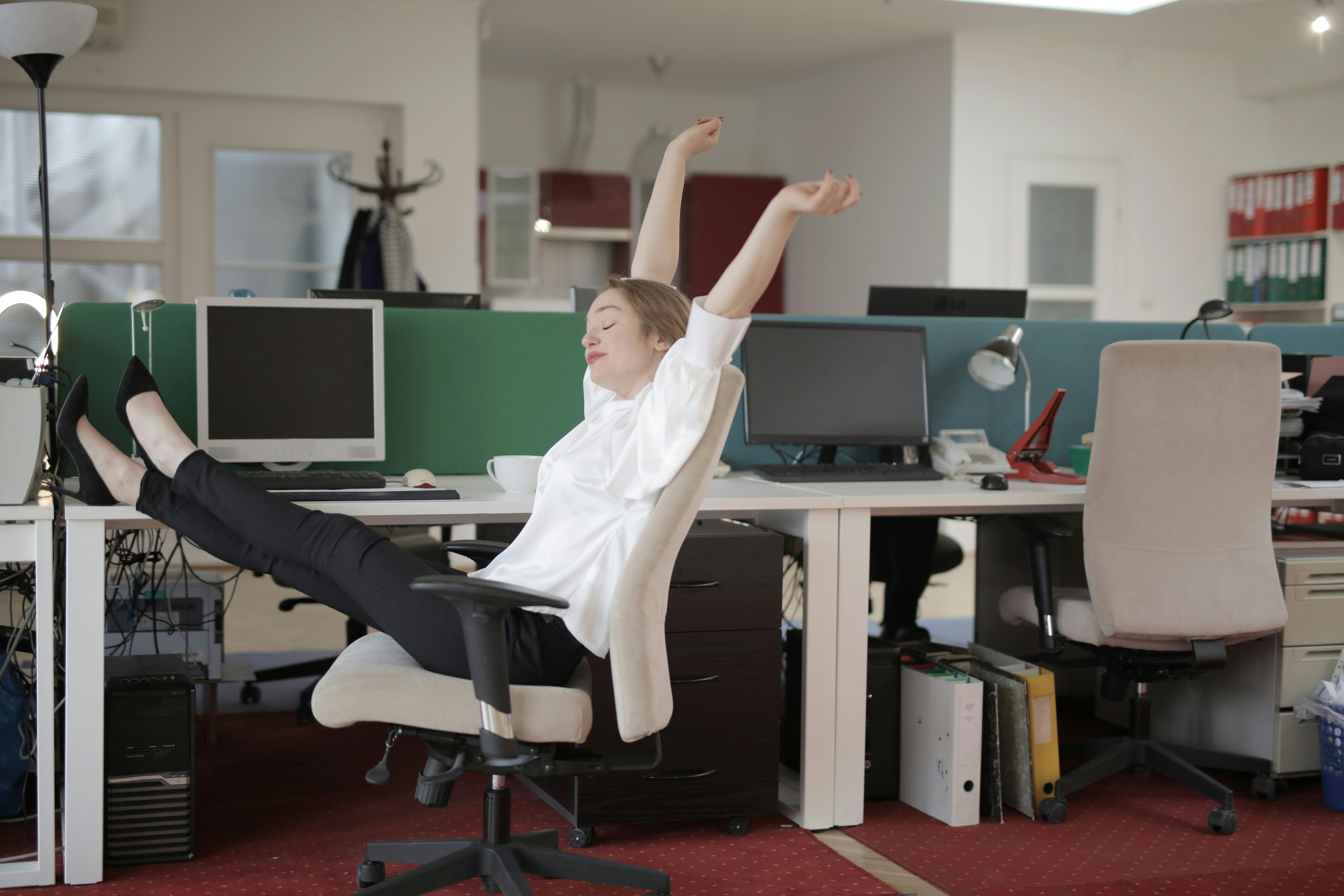 female office worker relaxing with feet on the table
