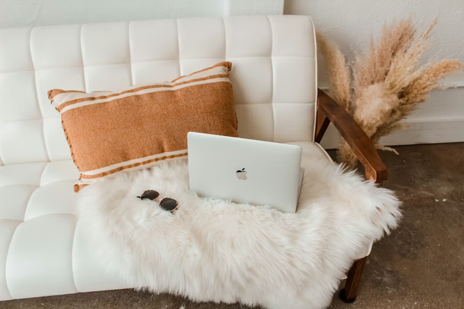 silver-macbook-on-white-fur-textile
