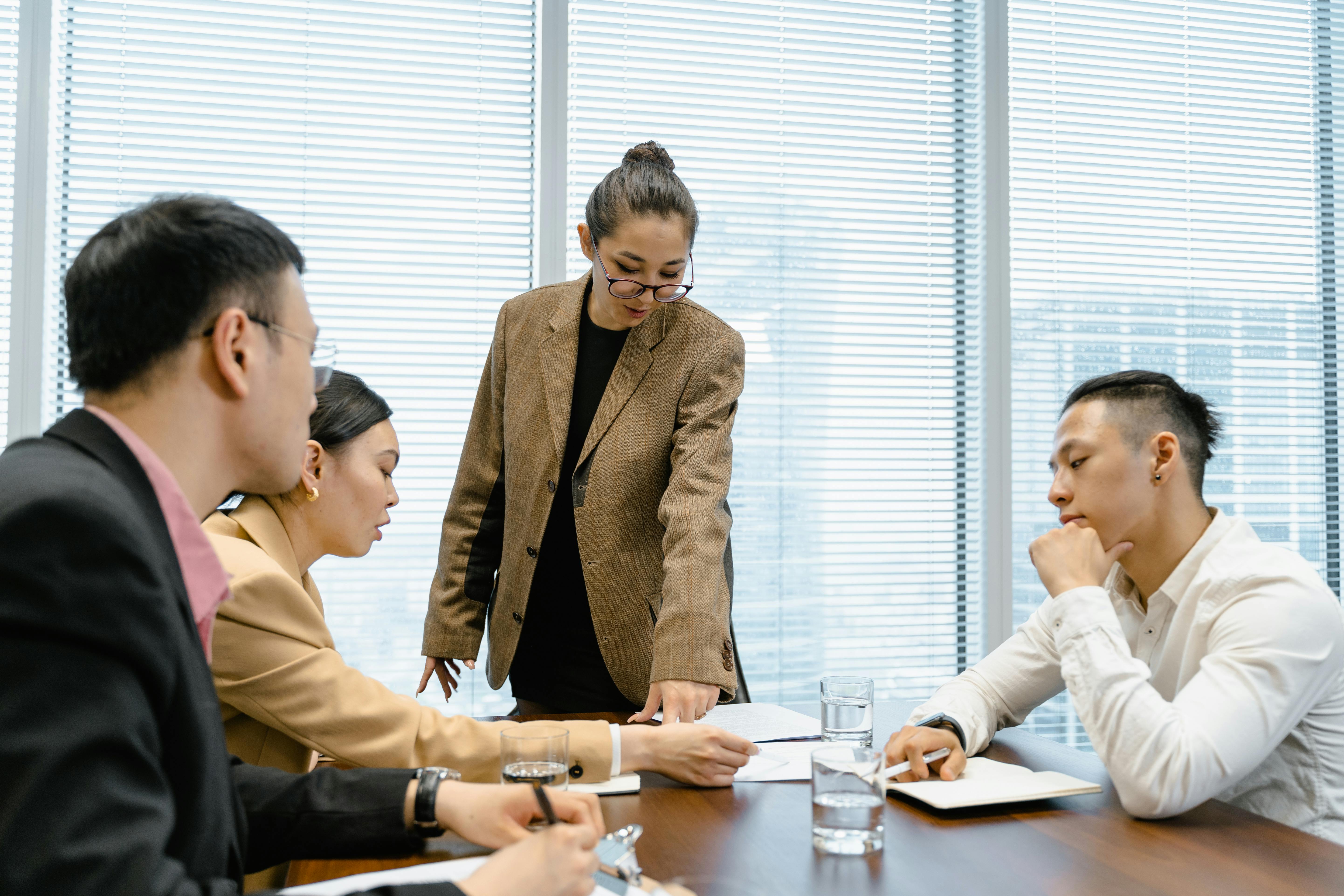 team-at-the-meeting-listening-to-woman-in-glasses