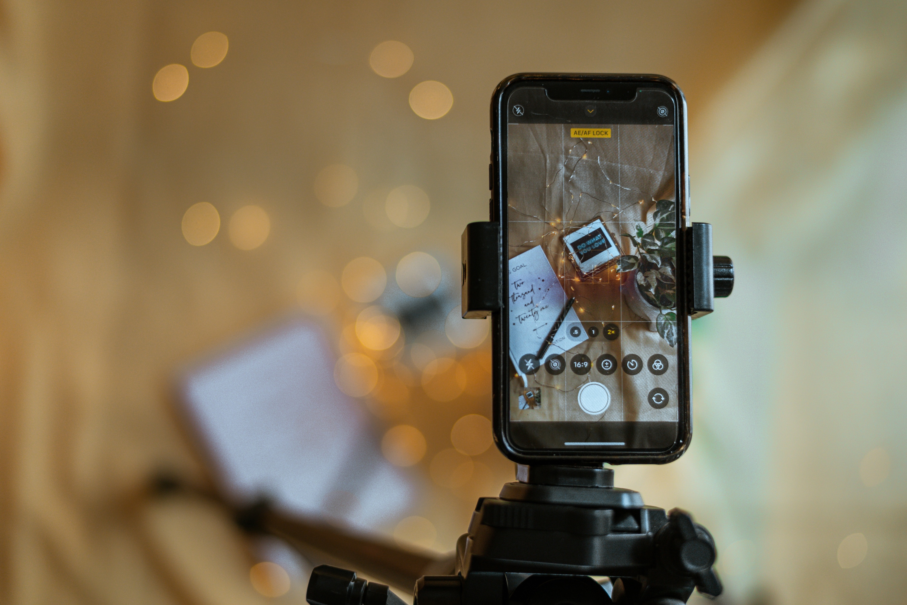 black-and-silver-camera-with-black-tripod