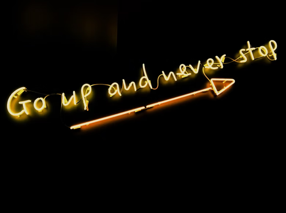 black-background-with-yellow-text-overlay-that-says-Go-up-and-never-stop