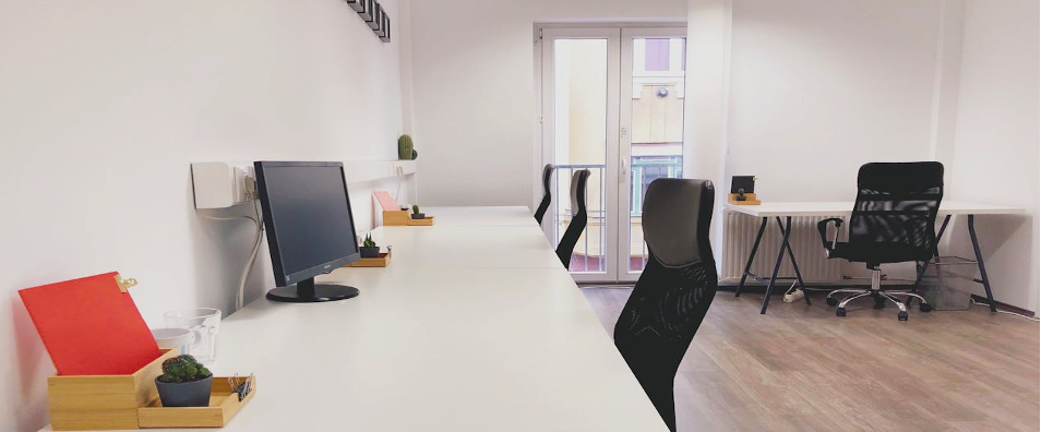 black-office-rolling-chair-beside-white-wooden-table