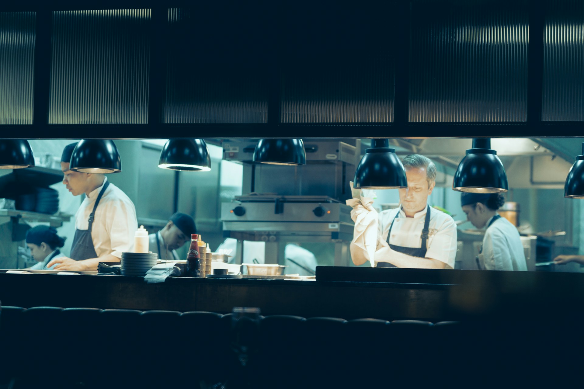 chefs-preparing-food-in-a-dark-kitchen