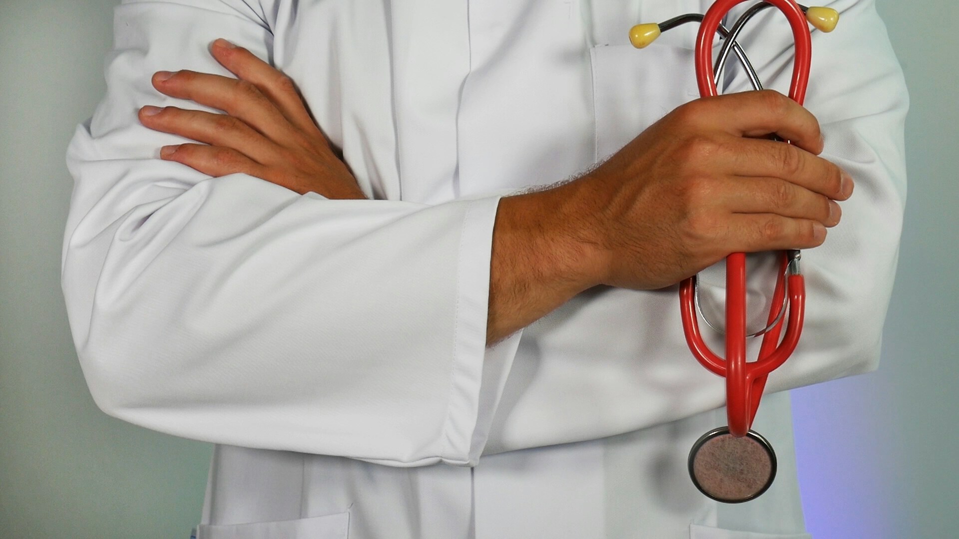 doctor-holding-red-stethoscope