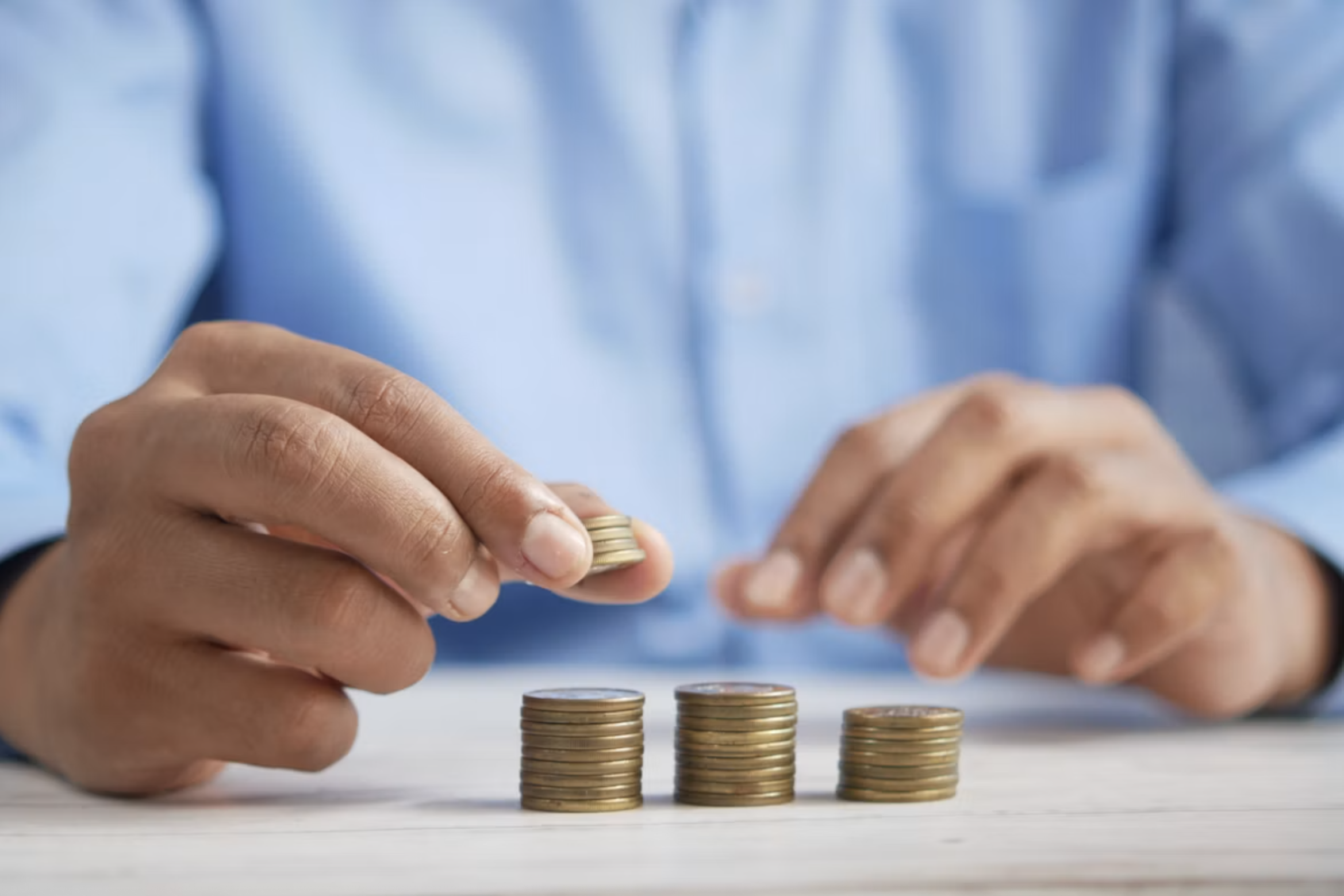 person gesturing during meeting with laptop hands and coins