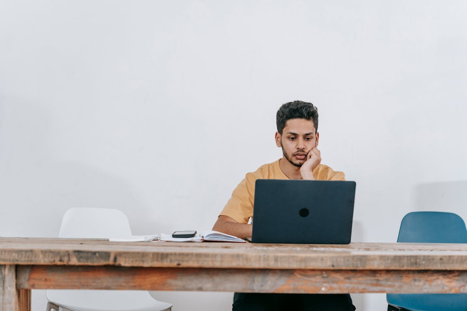 male-student-with-laptop-studying-online