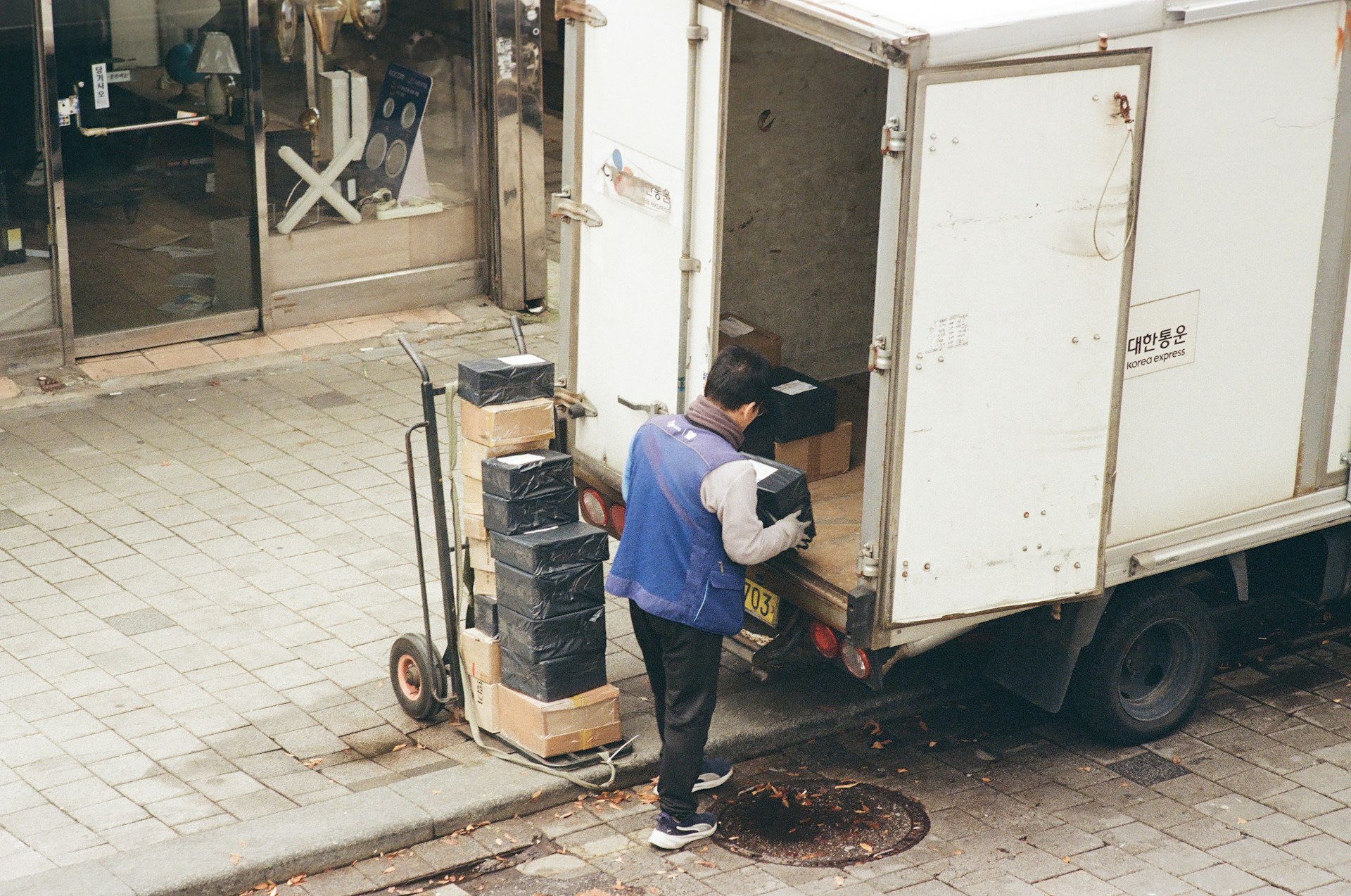 man-loading-boxes-from-a-truck-onto-a-dolly