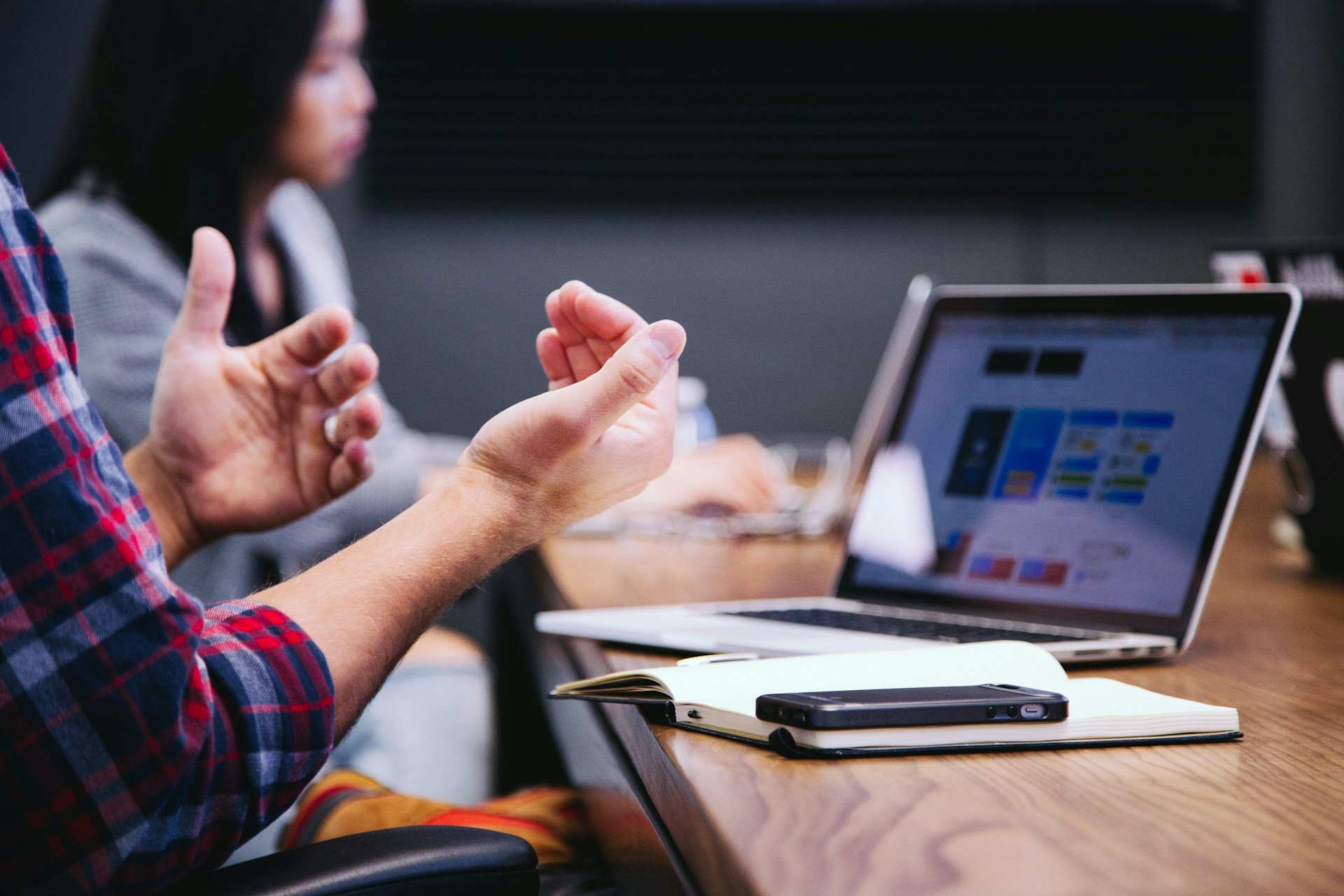 person gesturing during meeting with laptop person-gesturing-during-meeting-with-laptop