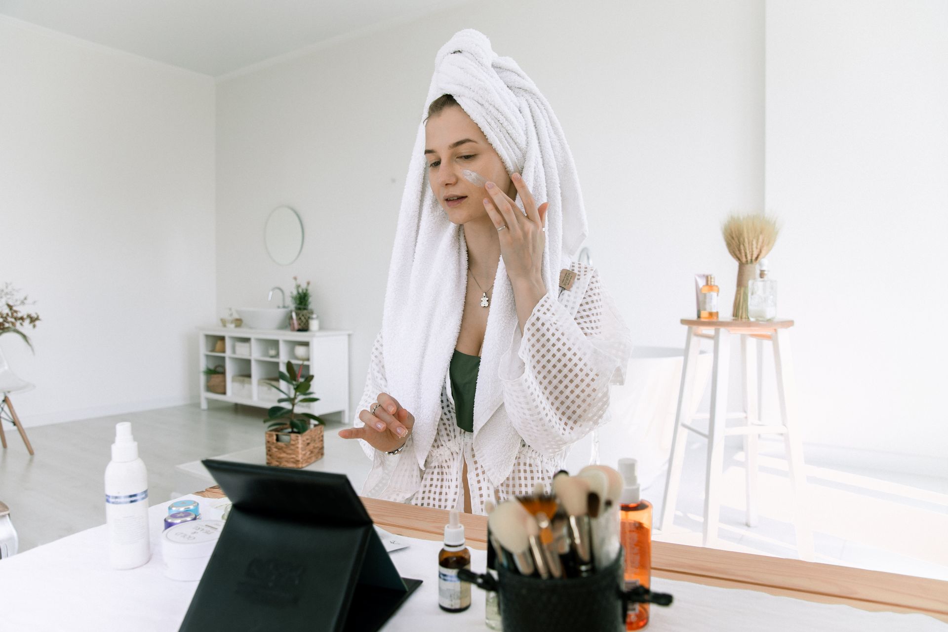 photo-of-woman-applying-cosmetics-on-her-face