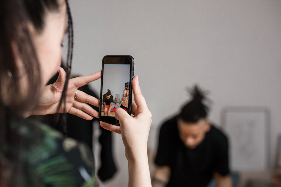 shallow-focus-of-a-person-holding-a-smartphone-while-recording