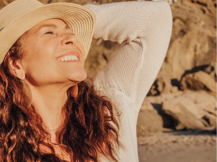 woman in white long sleeve shirt wearing white sun hat